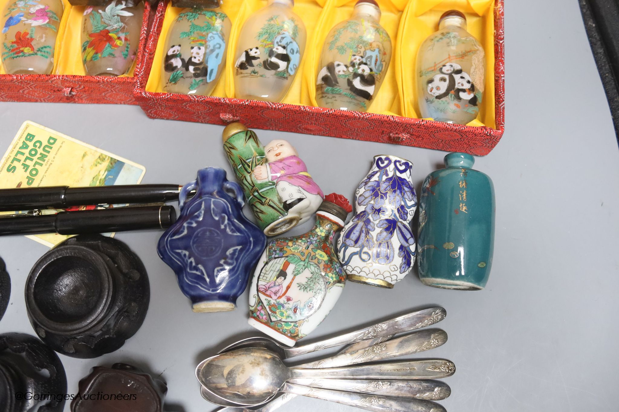 A collection of miscellaneous snuff bottles, figurative carvings, stands etc